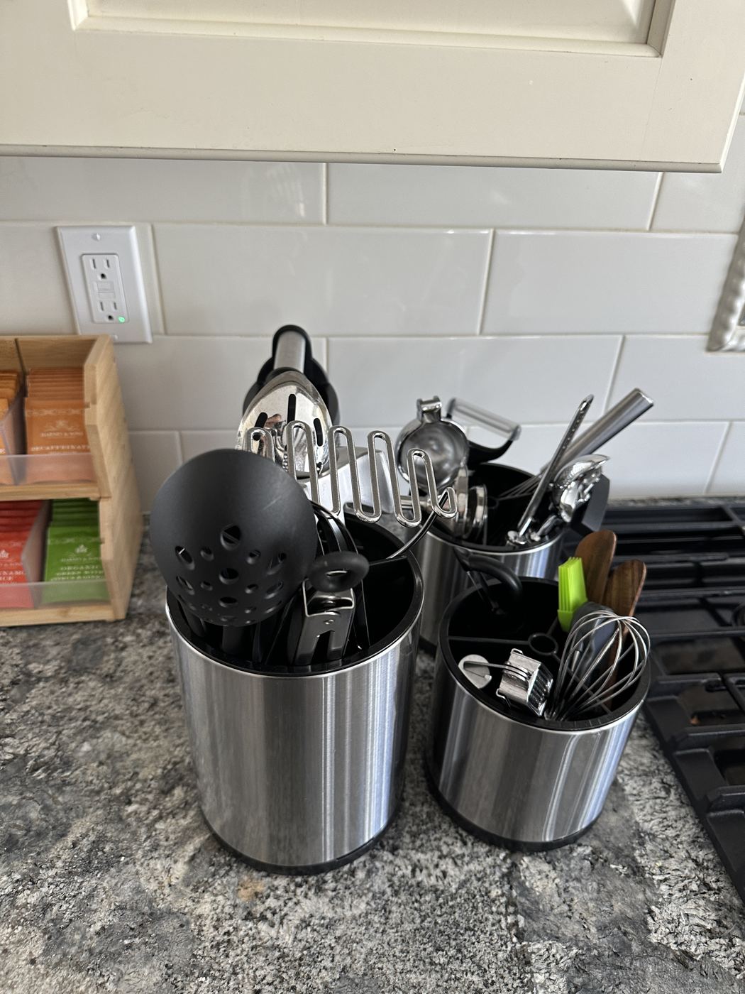 Utensil crocks beside the cooktop